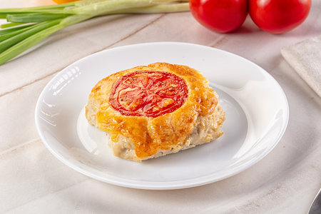 Chicken choplet baked with cheese and tomatoの写真素材