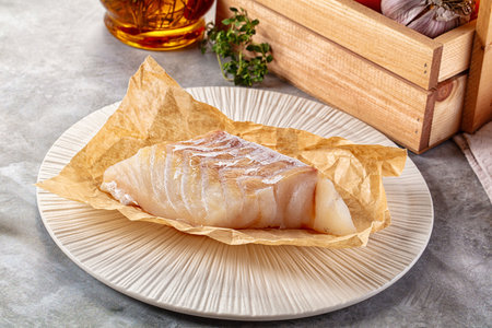 Raw code fish fillet for cooking over boardの写真素材