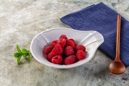 Organic ripe sweet juicy raspberry in the bowl