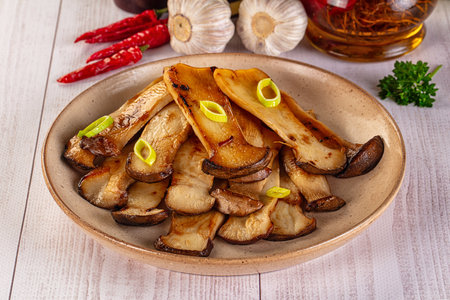 Vegan cuisine - Roasted eringi mushrooms in the plateの写真素材