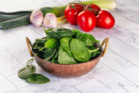 Raw fresh green spinach leaves in the bowlの写真素材