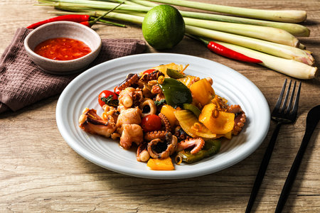 Roasted octopus with vegetables, spices and oilの写真素材