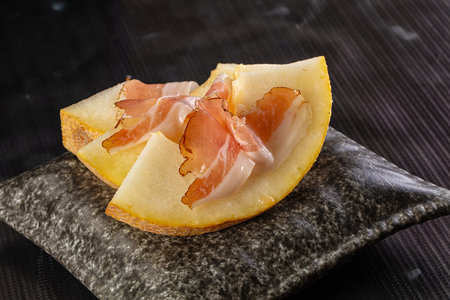 Slised sweet melon with Jamon serranoの写真素材