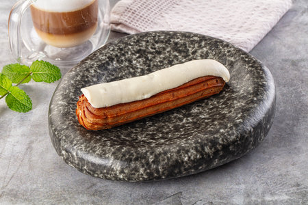 White delicous vanilla eclair with icing dessert