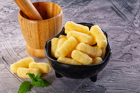 Golden crispy sweet corn sticks in the bowl for snackの写真素材