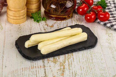 White mozzarella sticks over board snack