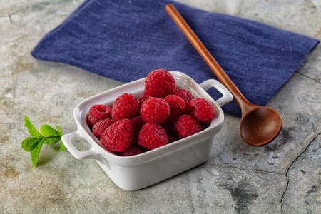 Organic ripe sweet juicy raspberry in the bowl