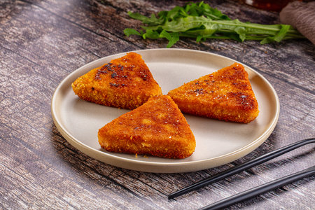 Fried golden cutlets triangles in the plate