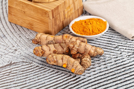 Fresh aroma turmeric roots heap served powder