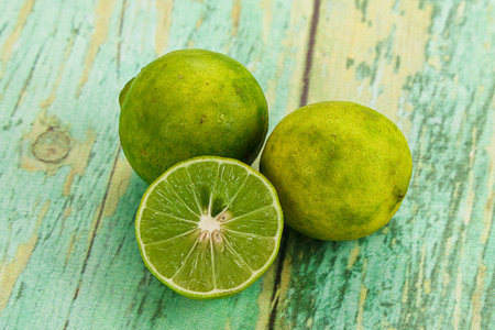 Fresh sour green lime fruit with half