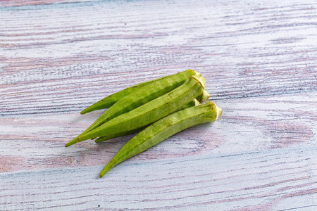 Raw organic green okra vegetable for vegan cuisine