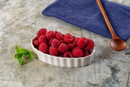 Organic ripe sweet juicy raspberry in the bowl