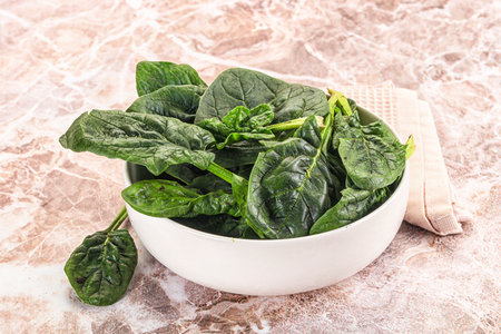 Fresh green spinach leaves heap in the bowl
