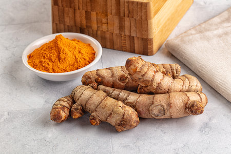Fresh aroma turmeric roots heap served powder