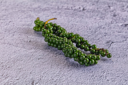 Fresh raw spicy green pepper corn in the branchの写真素材