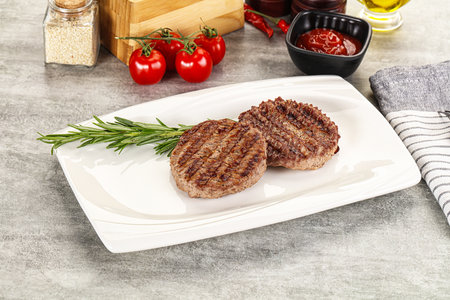 Grilled two beef burger cutlet served rosemary