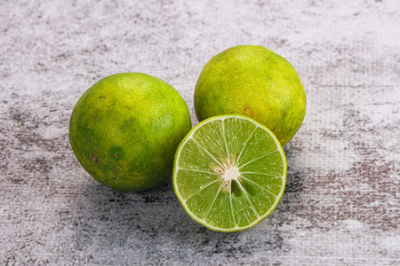 Fresh sour green lime fruit with half