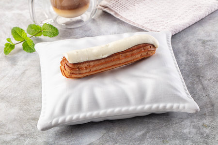 White delicous vanilla eclair with icing dessert