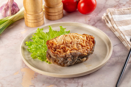 Roasted cod fish fillet piece in the plate
