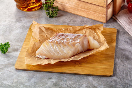 Raw code fish fillet for cooking over board