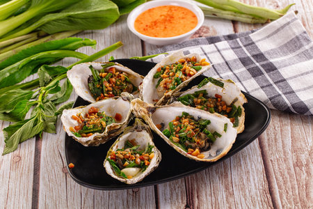 Gournet grilled oysters with green onion and peanutの写真素材