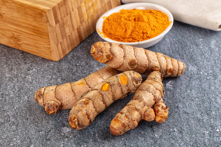 Fresh aroma tumeric roots heap served powderの写真素材