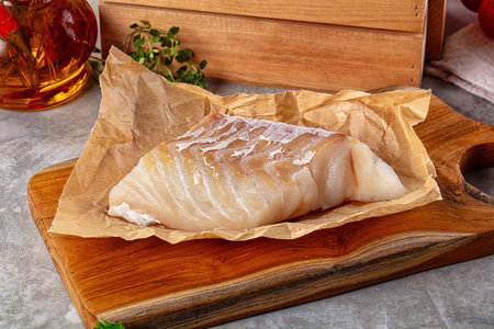 Raw code fish fillet for cooking over board