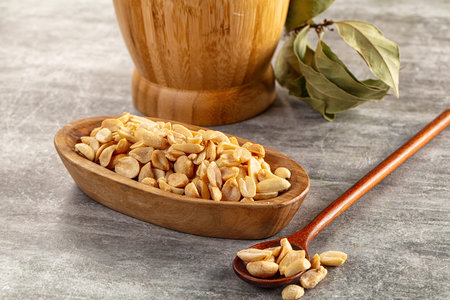 Tasty salted roasted peanut heap in the bowlの写真素材