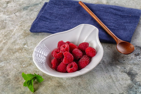 Organic ripe sweet juicy raspberry in the bowl
