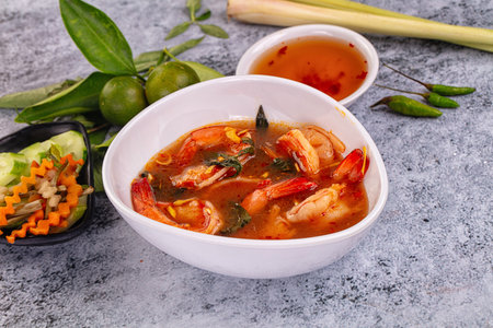 Asian sour spicy soup with prawn and herbs