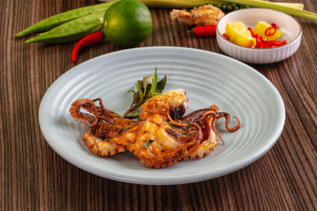 Gourmet grilled whole wild octopus served lime