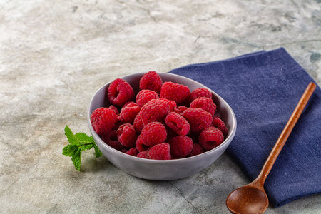 Organic ripe sweet juicy raspberry in the bowl