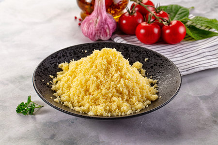 Boiled wheat couscous grain garnish in the bowl