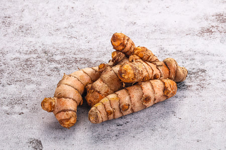 Fresh raw asian tumeric roots heap