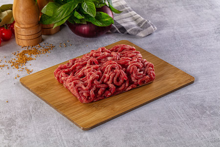 Raw minced beef meat over board for cooking