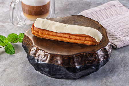White delicous vanilla eclair with icing dessert