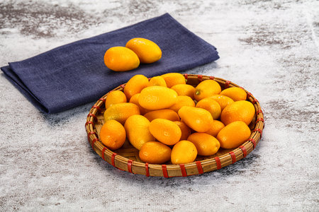 Sweet juicy tropical fruit kumquat heap in the bowl