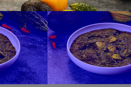 Vibrant bowl of green Palak Paneer, an Indian spinach and cheese curry. High-angle view on a dark...