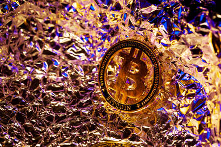 Bitcoin on surface with neon and gold reflections. Currency of the future. Halving. Money. Coin. Miningの写真素材