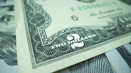 Macro shot of dollars. Stack of two dollars bills close-up.の写真素材