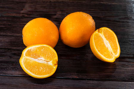 Orange, half of orange on the wooden table. Summer moodの写真素材