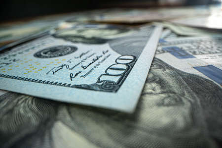 One hundred dollars. Macro shot. a lot of money on the table