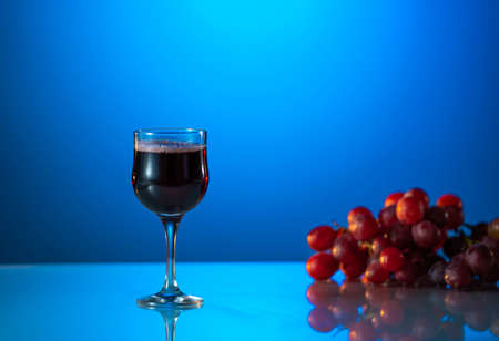 Glass of wine on a beautiful blue background. holiday moodの写真素材