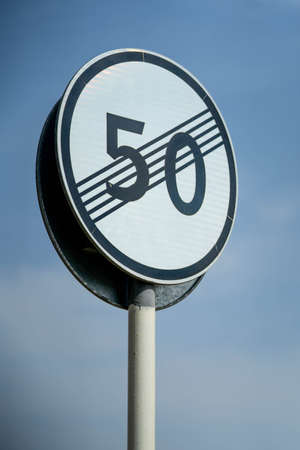 Speed limit zone ends sign on white background with clipping. Traffic signs. Spanish traffic signal: end of speed limited to 50 km per hour. Close up shotの写真素材