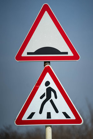 road sign warning pedestrian crossing. road sign for roughness on the road. close up shotの写真素材