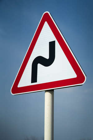 Road sign serpentine. dangerous turnの写真素材