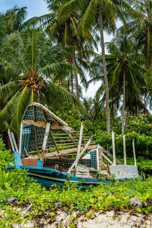 Broken board is on the beach. palm tree and boats at sunset on tropical island ko tao thailandの写真素材