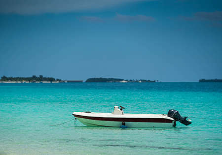 Boat on the beach at sunrise timeの写真素材