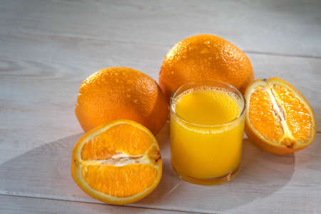 Orange jice is on the white tableの写真素材