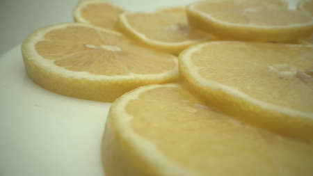 Sliced lemon fruits fresh background on white plate.の写真素材